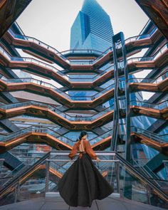 a woman standing in front of a tall building