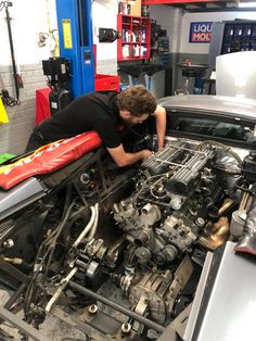 a man working on an engine in a garage