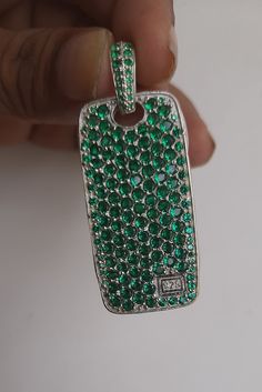 This Dog Tag Pendant is made with 925 Sterling Silver, pave with 5.83ct of lab created emerald. The pendant comes without a chain, it can be fit up to a 5mm box chain. Size: 25mm X 47mm (~57mm with bail) It holds simulated multi color gemstones with a total carat weight of approx. 5.83.cts. Emerald Cut Green Jewelry With Pave Setting, Green Necklace With Pave Setting As Gift, Green Bling Jewelry As A Gift, Green Pave Setting Jewelry For Gift, Green Jewelry With Pave Setting For Gift, Emerald Jewelry With Pave Setting As Gift, Emerald Jewelry With Pave Setting For Gift, Silver Emerald Rectangular Pendant Jewelry, David Yurman Ring