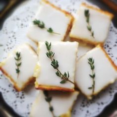 small pieces of food on a doily with some green sprigs in the middle