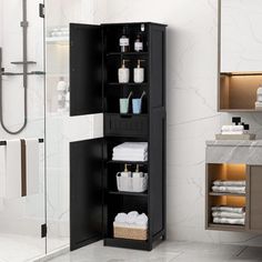 a bathroom with a black cabinet and white towels