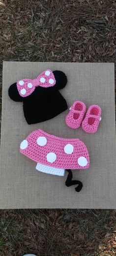 crocheted minnie mouse hat, slippers and booties are on the ground