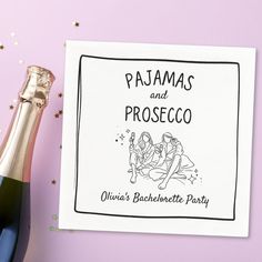 a bottle of champagne next to a card that says pajamas and prosceco