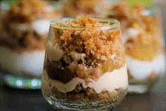 three desserts in small glass dishes with toppings on top, sitting on a table