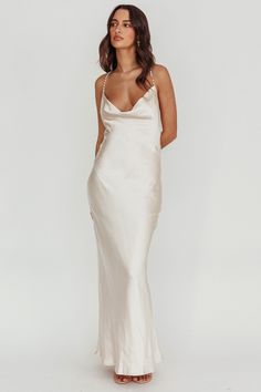 Satin maxi dress Mermaid silhouette Cowl neck Faux pearl crossover straps Backless No lining Jaws will drop when you walk by in our gorgeous Danijela maxi dress. Featuring faux pearl straps in the back and crafted with a soft, satin fabric. We're in love with the cowl neck and romantic opened back. It's perfect for bridal events or a birthday soiree. Team it with clear heels and a clutch for an unforgettable look. MODEL INFO Model is wearing size XS Height: 5'8" Bust: 31.0" Waist: 24.0" Hips: 35 Birthday Soiree, Pearl Straps, Bridal Events, Dress Champagne, Veil Hairstyles, Dress Mermaid, Mermaid Silhouette, Lace Bodycon Dress, Satin Maxi