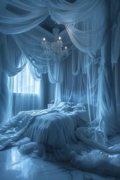 a bed covered in white sheets and drapes with a chandelier hanging from the ceiling