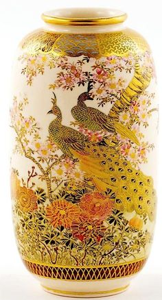 an ornate vase with two peacocks painted on it