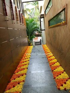 the walkway is decorated with orange and yellow flower garlands, along with other decorations