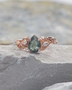 a close up of a ring on top of a rock