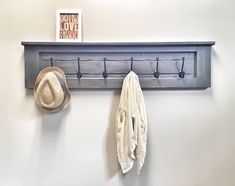 a coat rack and hat hanger on the wall