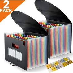 two black boxes filled with colored pencils and rulers