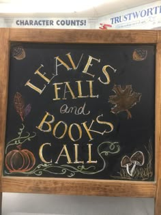 a chalkboard sign that says leave's fall and books call