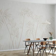 a dining room with a table and chairs in front of a wallpapered bamboo tree