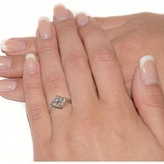 a woman's hand with two different manies and a ring on her finger