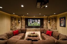 a living room filled with furniture and a flat screen tv mounted to the side of a wall