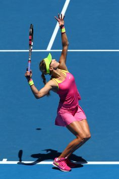 a female tennis player is getting ready to hit the ball with her racquet