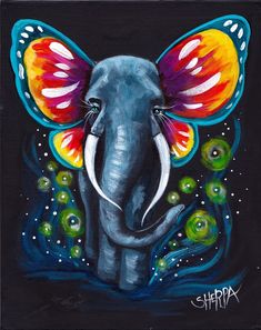 an elephant painted with bright colors on it's face