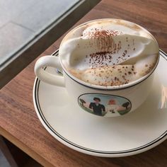 a cappuccino is sitting on a saucer