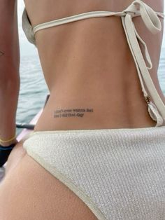 the back of a woman's body with words on it