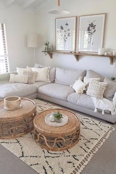 a living room filled with white furniture and pillows on top of a carpeted floor