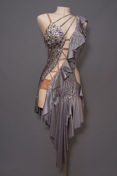 a mannequin wearing a silver dress with chains on it's neck and back