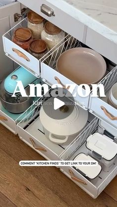 an open drawer with pots and pans in it