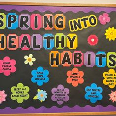 a bulletin board with the words spring into healthy habitits written in colorful letters and flowers