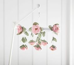 a mobile phone with pink roses hanging from it's display stand and price tag