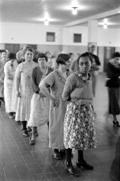 an old photo of women standing in line