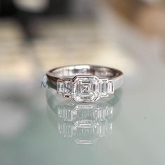 a diamond ring sitting on top of a table