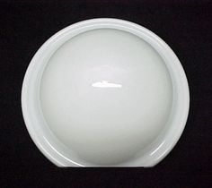 a white bowl sitting on top of a black table