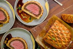 four plates with pastries on them sitting on a table