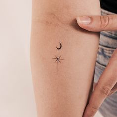 a woman's arm with a tattoo on it and a star in the middle