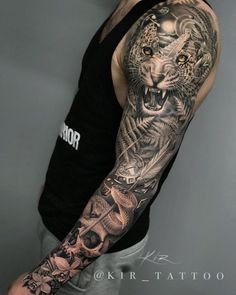 a man with a tiger and skull tattoo on his arm