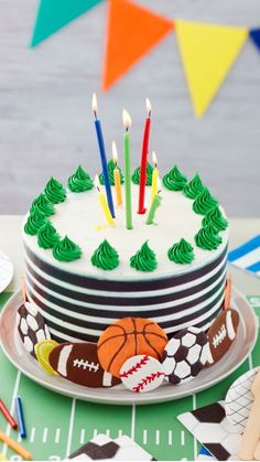 a sports themed birthday cake with candles on it