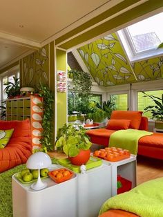 an orange and green living room with lots of furniture