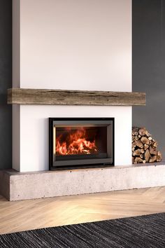 a fire place with logs in front of it