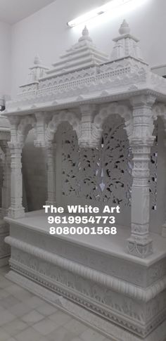 the white art is displayed in front of an empty room with tile flooring and walls