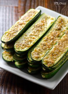 sliced zucchini on a white plate with parmesan cheese and seasoning