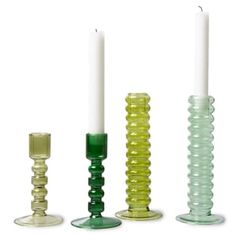 three glass candlesticks are lined up next to each other with one candle in the middle