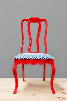 a red chair with a blue and white seat