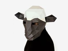 a black sheep with a white hat on it's head is standing in front of a white wall