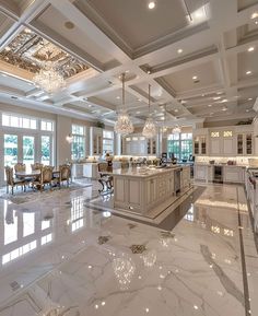 a large kitchen with marble floors and chandeliers