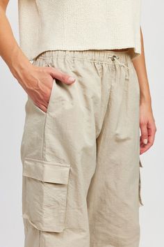 Cargo pants featuring a relaxed fit, side pockets and elastic around waist. The fun pants work for any season. Pair them with a sweater or a simple tee for an effortlessly chic look! Model is 5.9, wearing size S. Recommended sizing 2-4 S, 6 M, 8-10 L Pants With Elastic Waist, Dusty Sage, Athleisure Tops, Nylon Pants, Black Knit Dress, Cardigan Sweater Coat, Fun Pants, Denim Outerwear, Cargo Style