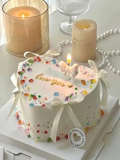 a birthday cake on a table with candles