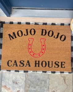 a door mat that says mojo dojo casa house with a horseshoe on it