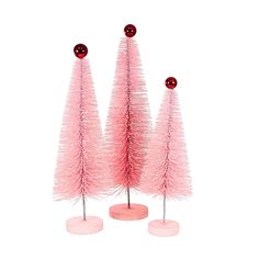 three pink christmas trees with red balls on top, one is small and the other is large