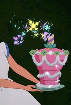 a woman in a white dress holding a pink birthday cake with sparkles on it