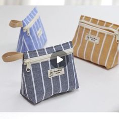 three small zippered pouches sitting next to each other on a white counter top