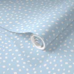 a light blue and white wallpaper with small white polka dots on the background,